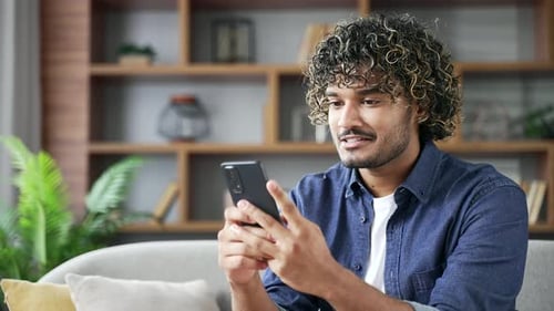 Adult using Mobile Phone Indoors on Couch