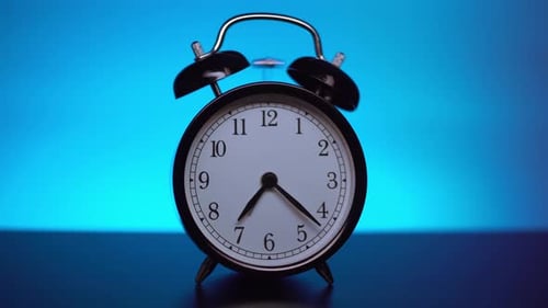 Black Alarm Clock On A Blue Background