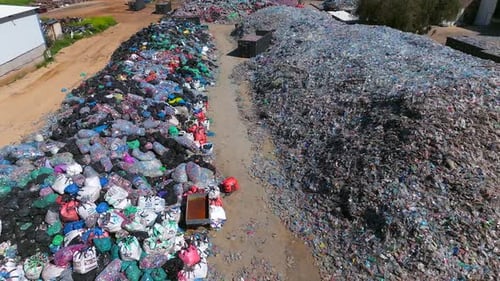 Plastic bottles and Trash Soda cans recycling piles in a local facility, Top down view