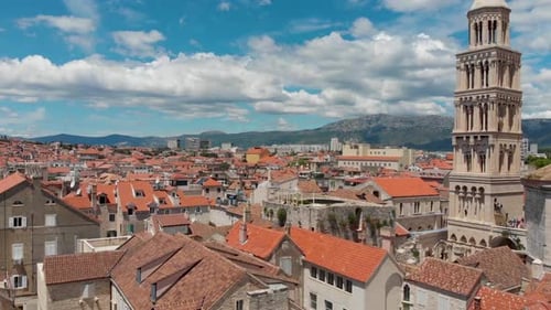 Ascending aerial view of a European old town with a medieval church tower
