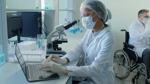 Female Scientist Using Microscope in Laboratory Setting