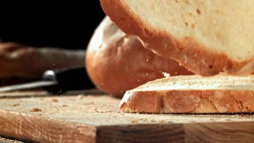 Sliced Bread Falls Onto a Cutting Board Filmed on a Highspeed Camera at 1000 Fps