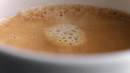 Pouring Coffee in a White Cup Close Up