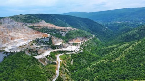 Natural Quarry is Located Near Road Against Backdrop of Rhodope Mountains and Hills with Forests and