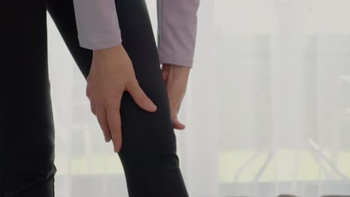 Woman Massaging Knee, Close Up