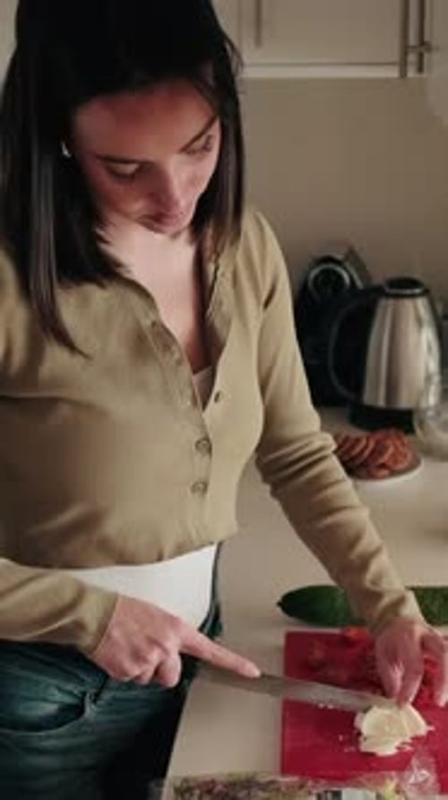 Woman Cuts Tomatoes and Mozzarella in Kitchen