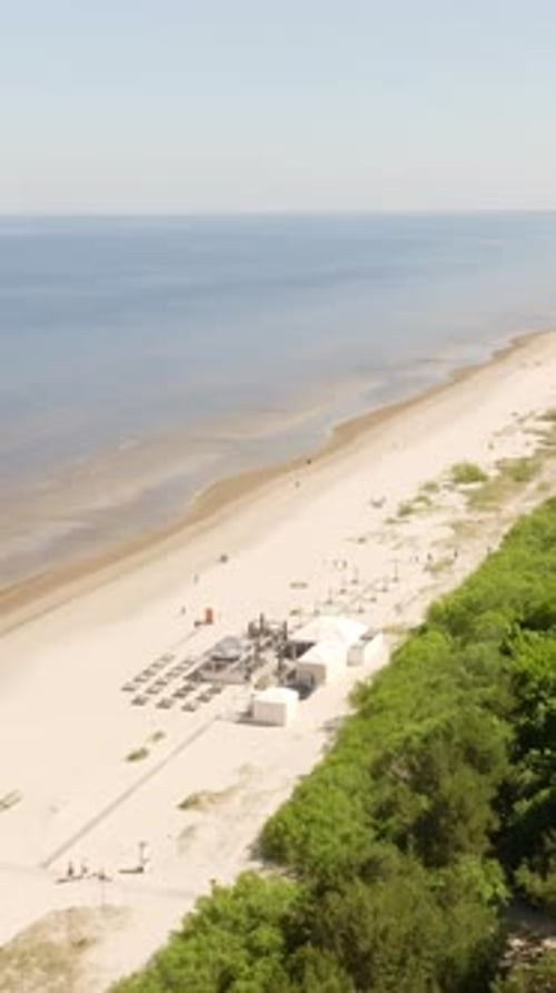Vertical drone shot circling the Jurmala beach, sunny, summer day in Latvia