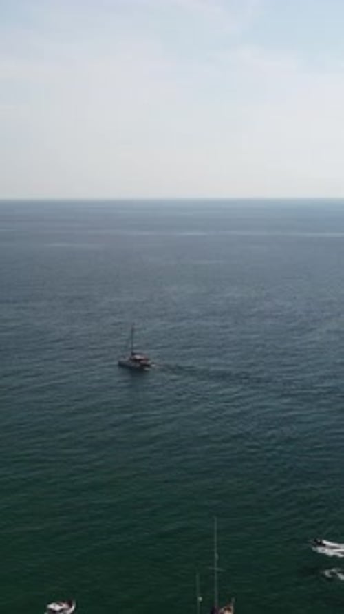 Aerial Vertical View of Seascape with Crystal Clear Azure Sea and Rocky Shores Yachts in a Beautiful