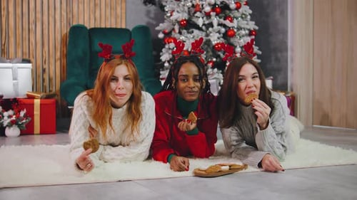 Friends Enjoying Christmas Cookies Together Indoors
