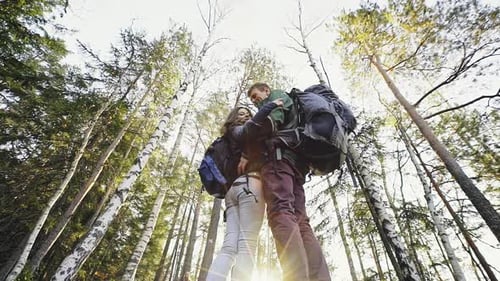 Content Couple of Tourists Posing in Woods