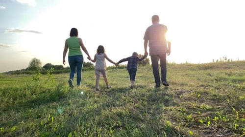 Rear View of Family with Two Children Spending Time Together Outdoors