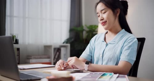 Young Woman Talking to Laptop at Desk
