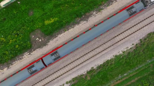 Slow motion Passenger train on a countryside railroad, Top down aerial view