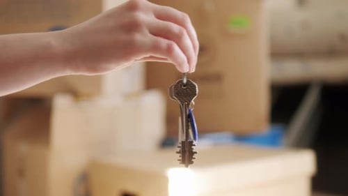 Closeup the Keys to a New Apartment are Put in the Hand of the Buyer