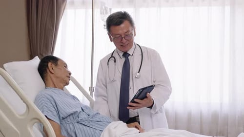 Doctor Explains Diagnosis to Senior Man in Hospital