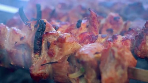 Juicy Meat Kebabs Cooking on Skewers Close Up
