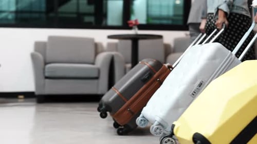 Close up Young people pulling suitcase and walk in airport.