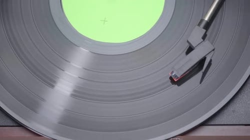 Close up of a Vinyl Record Spinning with green screen croma on vinyl cover.