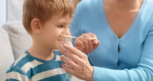 Child Using Nebulizer with Assistance in Home