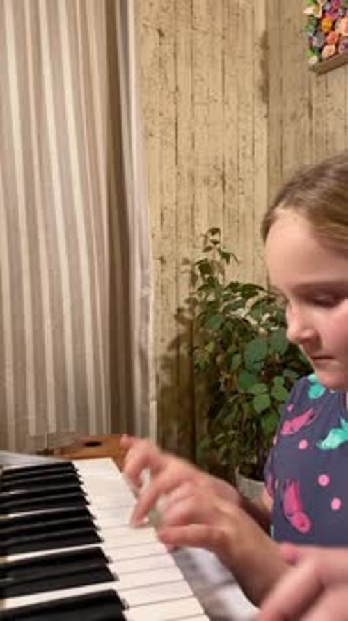 Girl Learning Piano at Home with Teacher
