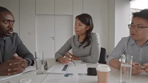 Three Professionals Collaborate in a Modern Office