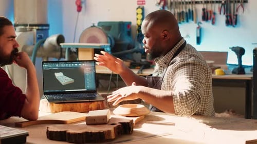 Woodworkers Designing Custom 3D Furniture on Notebook in Studio