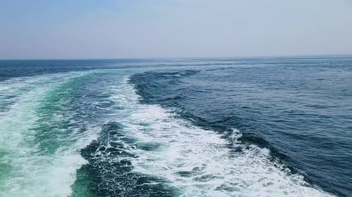 Wake On Turquoise Ocean Surface Created By A Sailing Ship. POV