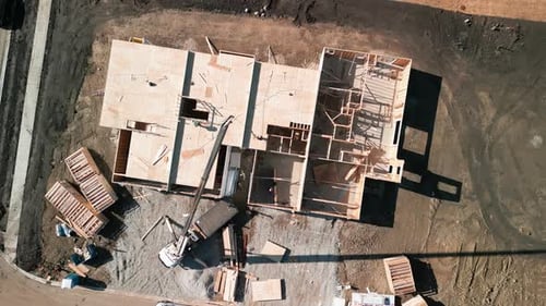 Aerial Above View the a New House Under Construction Wood Framing Beams at Sunny Day