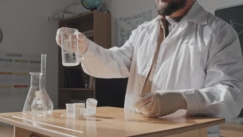 Scientist Examines Liquid in Laboratory Setting