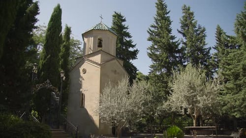 A Church tower in the trees, cinematic view of The Sioni Cathedral of the Georgian Orthodox cathedra
