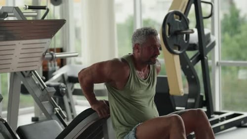Man Doing Tricep Dips in a Modern Gym