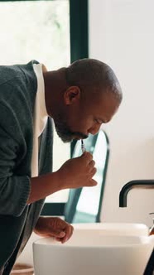 Man, brushing teeth and dental care with toothbrush in bathroom, home or wash mouth for fresh