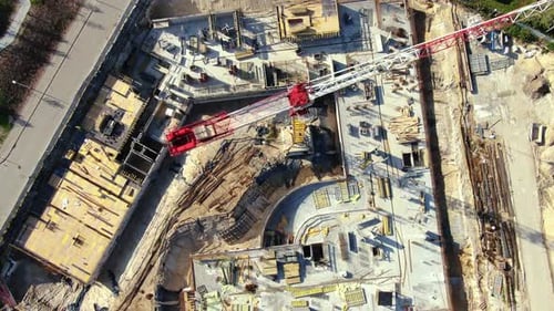 High building construction site. Big industrial tower crane with blue sky amd cityscape on backgroun