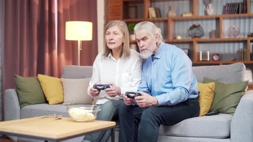 Senior Couple Enjoying Video Games in Living Room