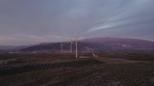 Wind turbine farm. Panoramic aerial view of wind turbines at sunset.
