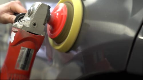 Man Using Power Buffer on a Car