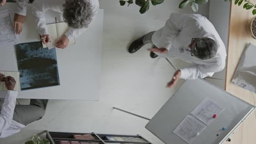 Group of Doctors Discussing New Clinical Recommendations in Office