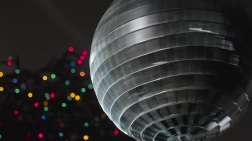 Spinning Disco Ball Near Christmas Tree with Lights