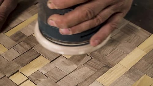Close shot of a machine sanding wood