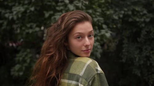 Woman with Long Hair Poses Outdoors