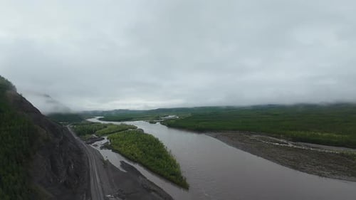 Stunning drone FPV exploration of a river winding through lush green landscapes in remote wilderness
