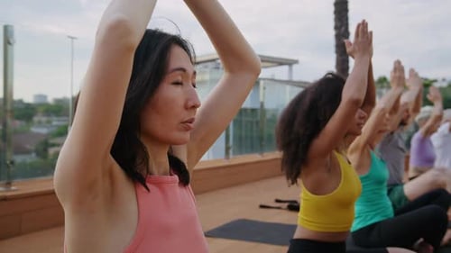 Yoga Class on Rooftop with Arms Raised