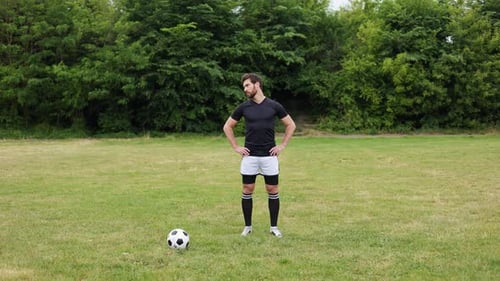 Focused Man Performing Neck Stretching Against Backdrop of Dense Forest