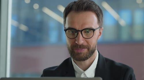 Close Up of Man Working on Laptop in Office