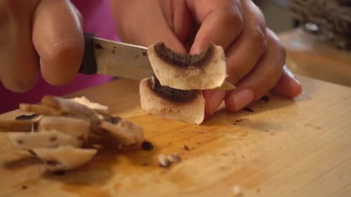 Slicing Mushrooms on a Cutting Board for Cooking