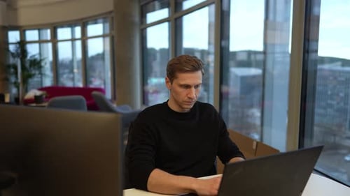 a programmer works at a computer, programs a neural network