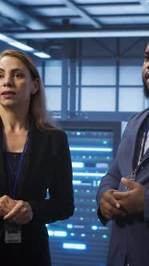 Vertical Video Teamworking Colleagues Looking at Holograms in Data Center Working Together