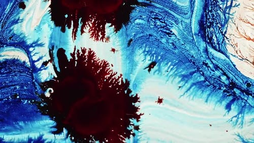 Red and Blue Ink Dropped into White Liquid