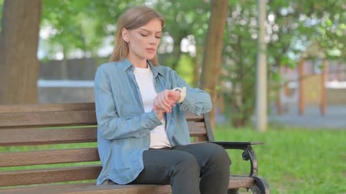 Woman Waiting on Park Bench Checking Watch