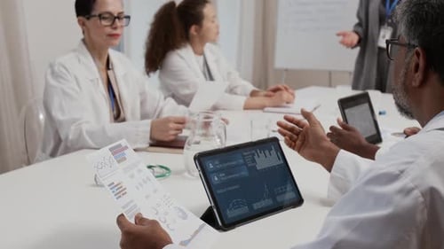 Medical Professionals Reviewing Data and Charts in Meeting